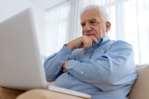 A man ponders while looking at a laptop. How Do I Know I Have a Cracked Heat Exchanger?