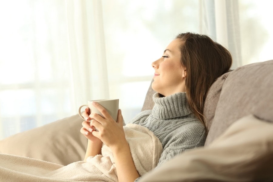 Woman relaxing in the comfort of her zone control system