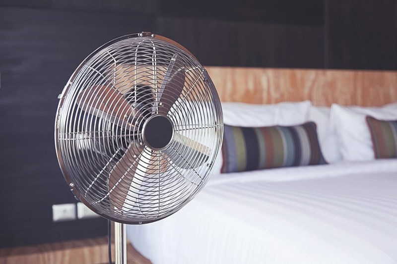 A fan next to a bed | Improve Your Home's Indoor Air Quality | Fort Collins