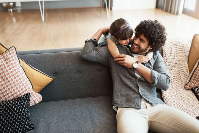 Image of parent and child on couch. Why Is a Home Dehumidifier Important?