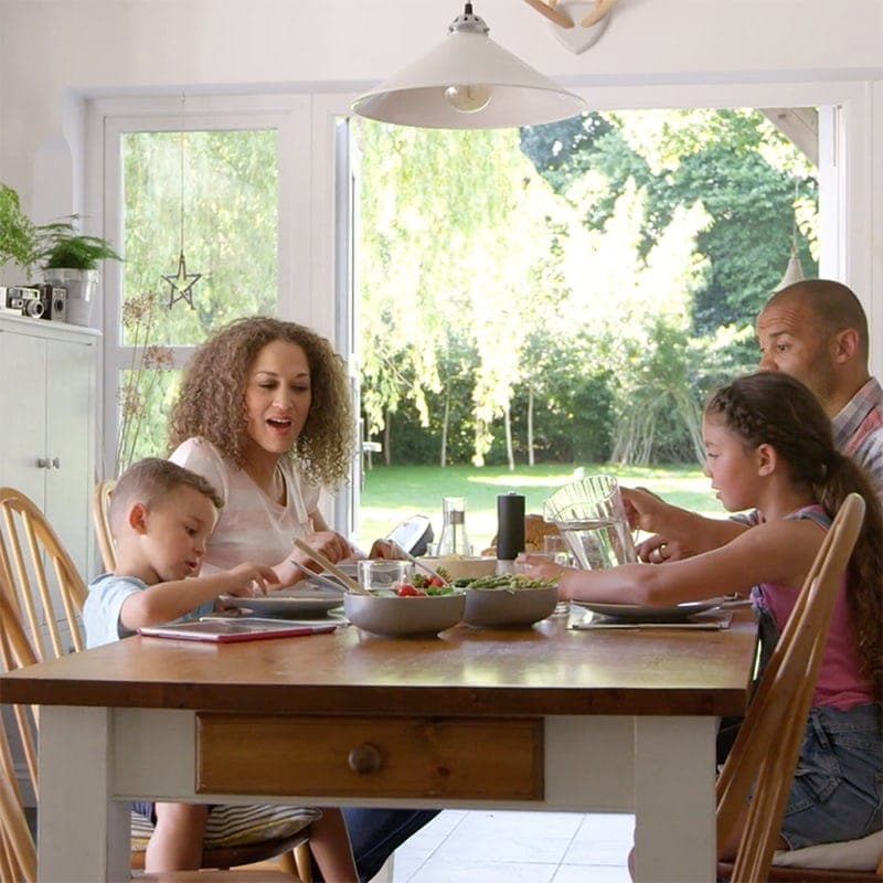 A family enjoying a meal around a table | Video - Indoor Air Quality Affects Your Family's Health|