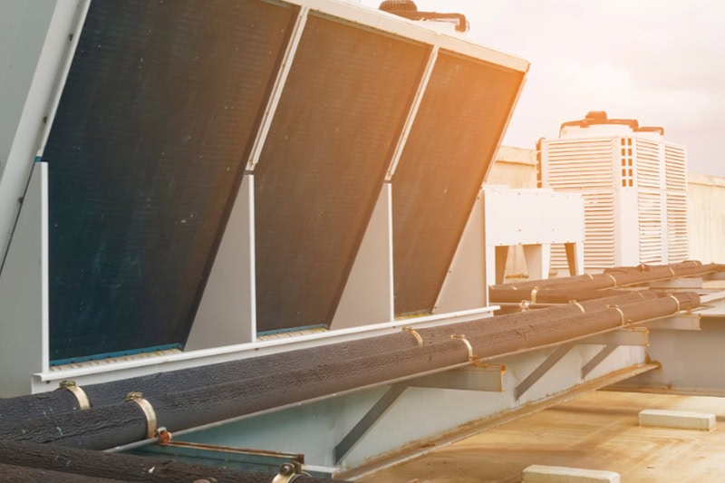 Should I Repair or Replace My Commercial Heating System? A heating unit on top of a building.