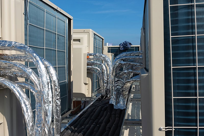 When to Upgrade Your Commercial HVAC System. Photo of HVAC units installed on a rooftop.