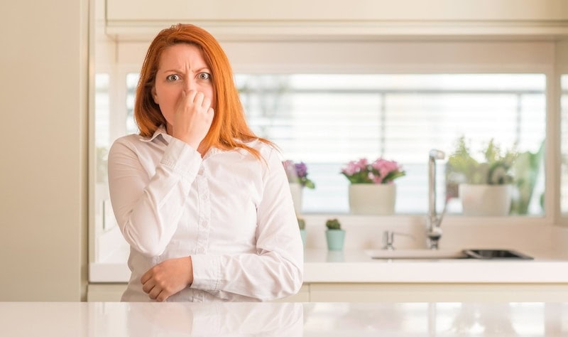 Woman smelling odor